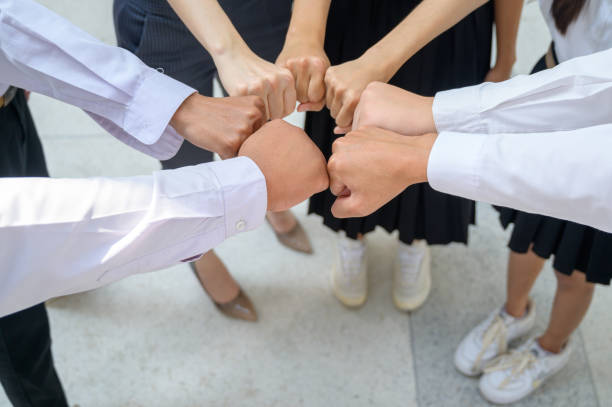 istock A group of friends extended their arms to touch their hands for unity. 1369147332