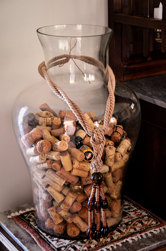 A large, decorative jar for storing wine bottle stoppers over the furniture