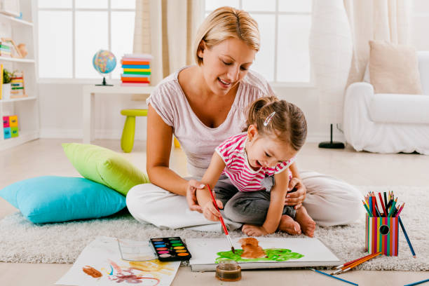 istock Mother and child having fun painting 1369148127