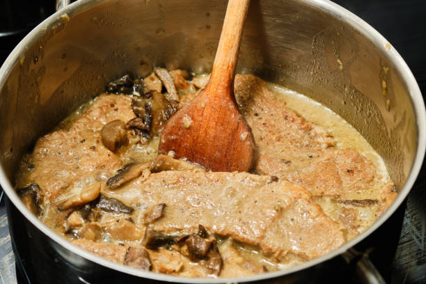 istock Cooking mushroom gravy with pork meat 1369149470