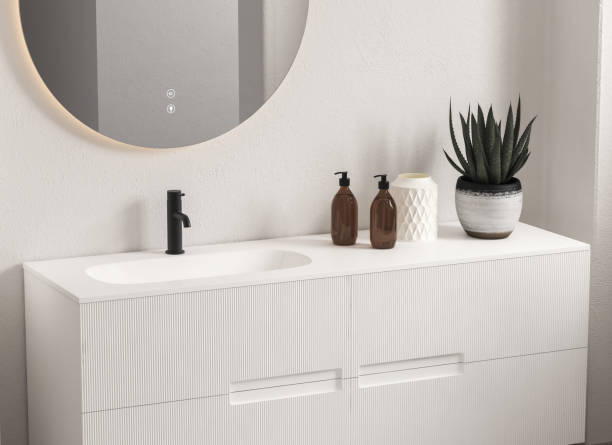 istock Close up of sink with oval mirror standing in on white wall. 1369149500