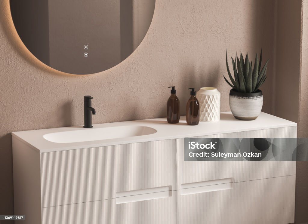 Close up of sink with oval mirror standing in on beige wall Close up of sink with oval mirror standing in on beige wall , white cabinet with black faucet in minimalist bathroom. Side view. 3d rendering Sink Stock Photo