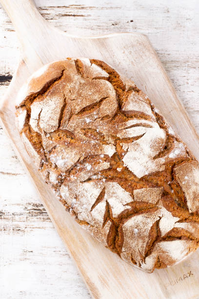 istock Sliced rye bread on cutting board, closeup. 1369150027