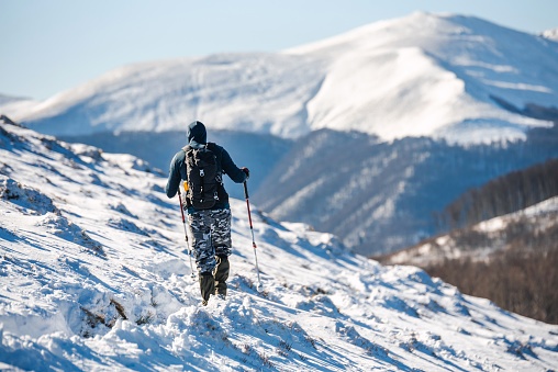 Mountain Hiker. Man trekking in the mountains during winter.