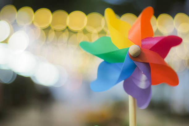 istock Colorful pinwheel with golden bokeh background 1369151013