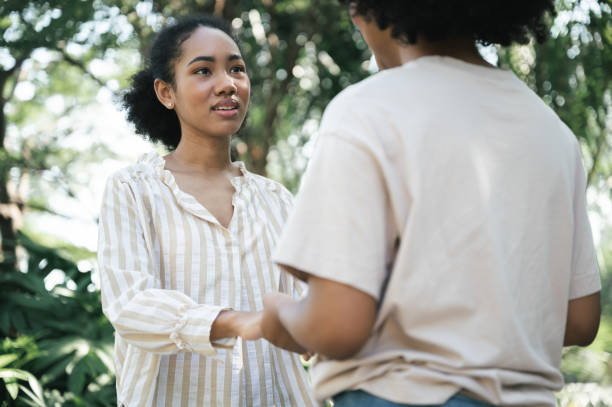 istock Emotion relationship two young woman talking in the garden 1369151476