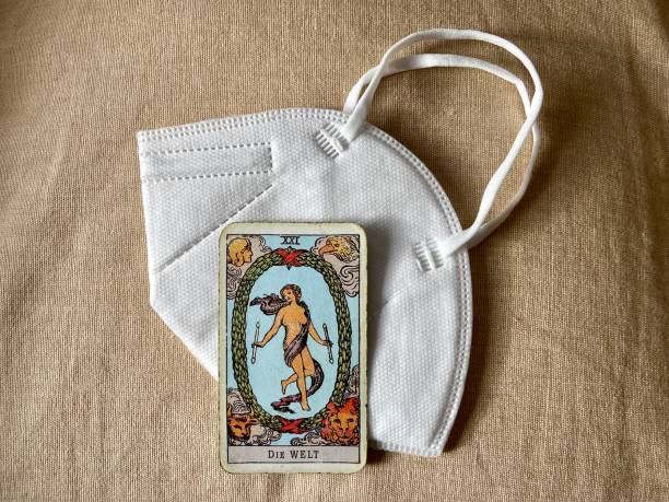 istock coronavirus situation: Tarot card on Covid protective face mask 1369151654