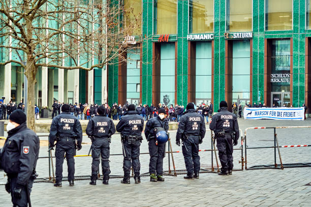 Police officers in black uniforms block a gathering of right-wing demonstrators against restrictions because of the Corona pandemic Braunschweig, Germany, January 8, 2022: Police officers in black uniforms block a gathering of right-wing demonstrators against restrictions because of the Corona pandemic alternative for germany photos stock pictures, royalty-free photos & images