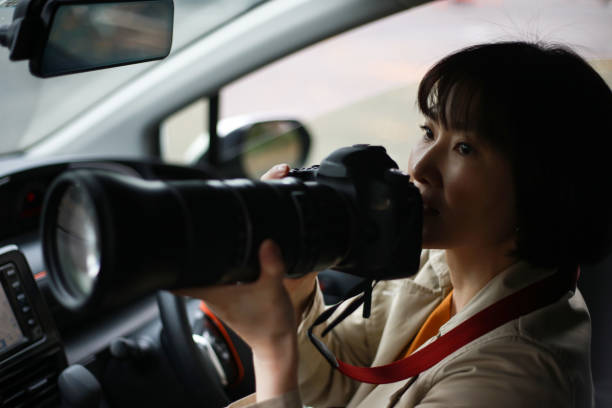 istock A woman taking a picture from inside the car 1369154469
