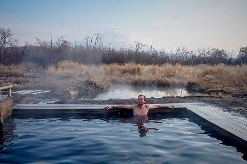 A guy in a natural thermal spring in Kamchatka peninsula