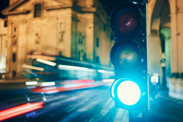 istock Green on traffic light against light trails of tram