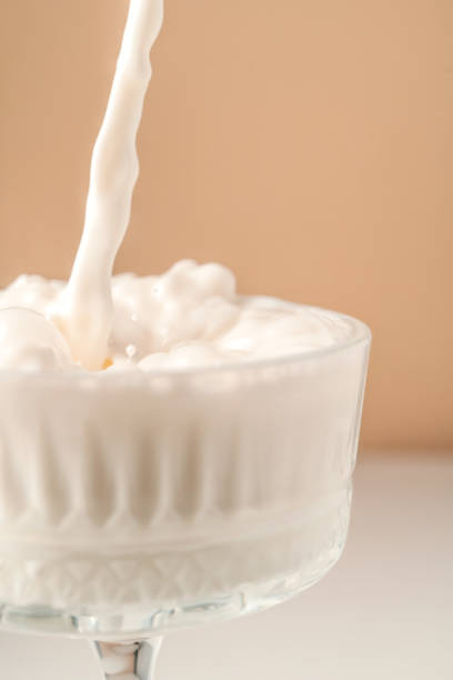 istock Milk pours into a beautiful crystal glass and splashes around. 1369156388