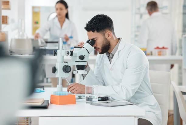 istock Shot of a young scientist using a microscope in a lab 1369158036