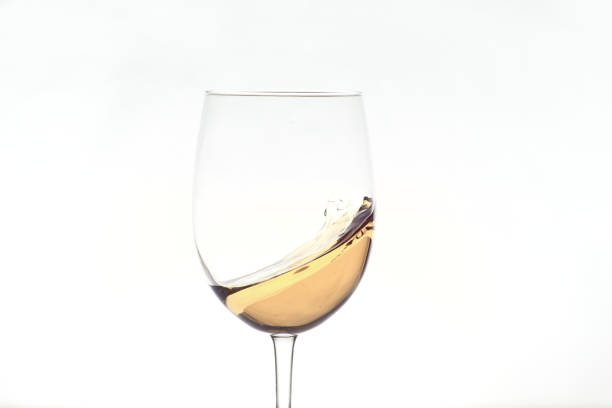 istock glass of white wine splashing on white background 1369158175
