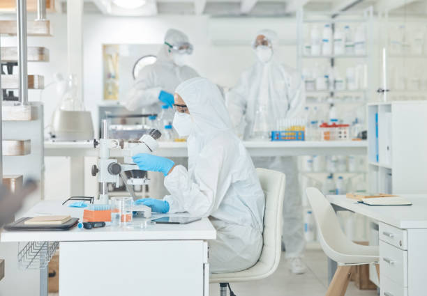 istock Shot of a scientist wearing a radiation suit while using a microscope in a lab 1369158273