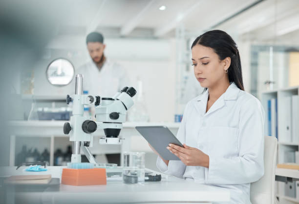 istock Shot of a young scientist using a digital tablet while working in a lab 1369158329