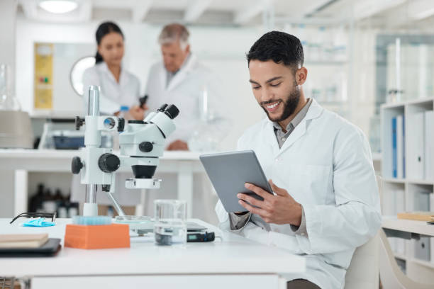 istock Shot of a young scientist using a digital tablet while working in a lab 1369159164