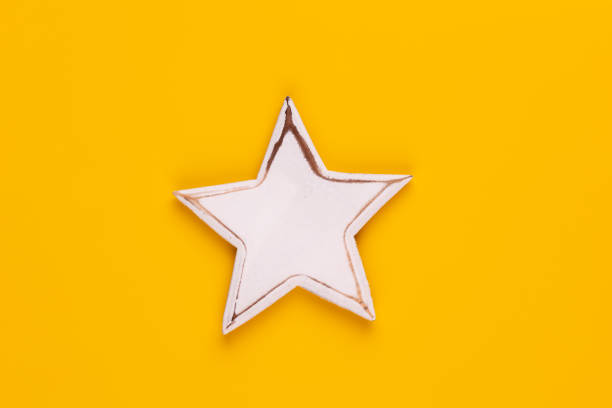 istock Christmas star decor on yellow colored background. 1369160729