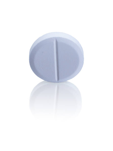 istock Medical pill close-up on a white background with reflection 1369160749