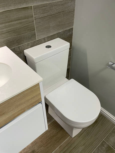 istock Image of modern bathroom with large rectangular freestanding sink wash basin vanity unit, wood effect wall tiles, wooden flooring 1369160996