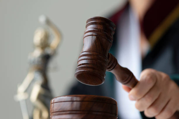 istock Female Judge Holding Gavel 1369162412