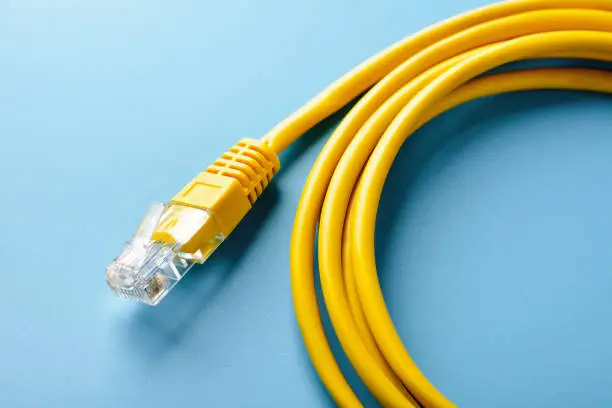 Photo of Network cable on blue background close up