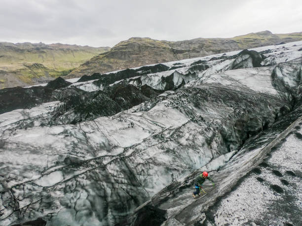 istock Man climbing up crevasse in glacier, Iceland 1369163146