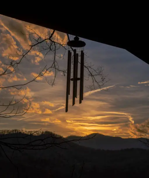 Evening sky over the Blue Ridge Mountains with silhouette of wind chimes.