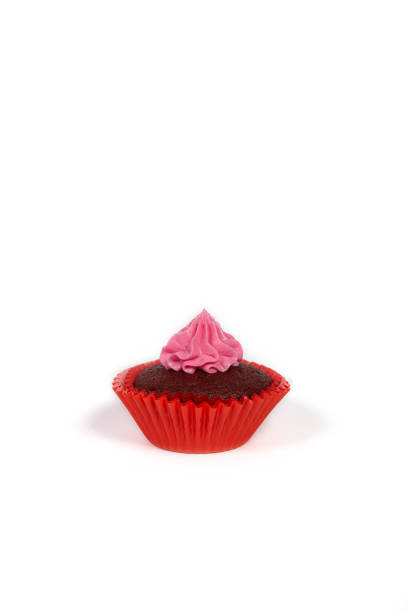 istock Cute cupcake isolated on a white. Cupcake with pink cream on a white with copy space. 1369164695