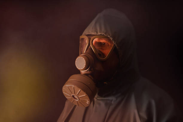 istock In the firelight with a gas mask. 1369165778