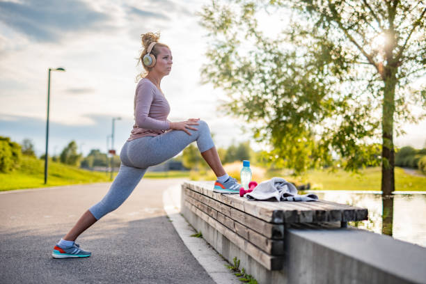istock Woman stretching her leg at the bench 1369165890