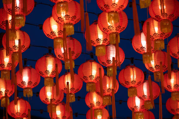 istock Rows of colorful glowing red Chinese lanterns 1369166053