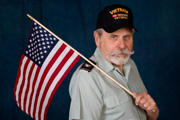 istock Retired Army Colonel American Flag over shoulder looking at camera 1369166213