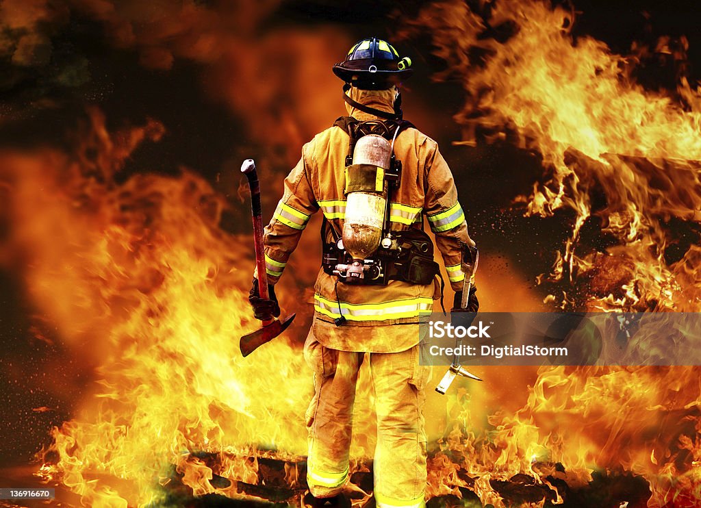 Into the fire Firefighter searching for possible survives. Firefighter Stock Photo