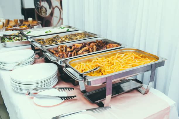 istock Cuisine Culinary Buffet Dinner Dining Food Celebration Party Concept. Trays with main meals - french fries chips, rice, meet and fish. Service at business meeting, weddings. Selective focus 1369167387