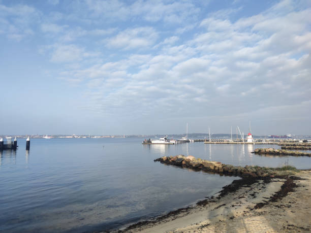 istock Baltic sea with empty harbor and small lighthouse 1369167816