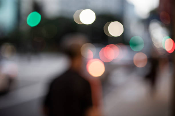 Unrecognisable person defocused on  street  by dusk