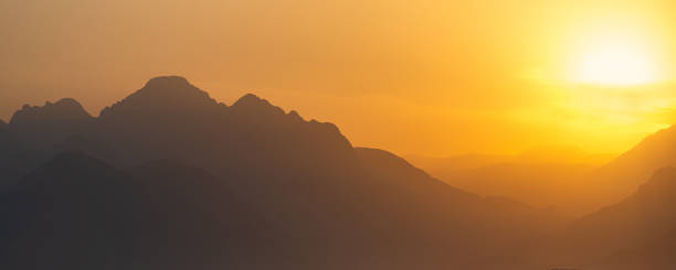 istock natural landscape - misty mountains at sunset 1369171534