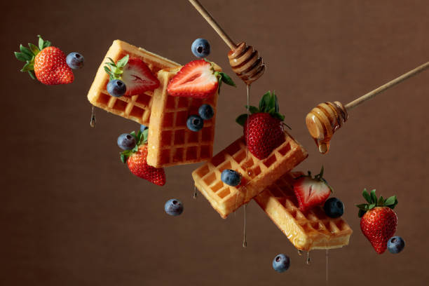 istock Waffles with blueberries, strawberries, and honey. 1369172021