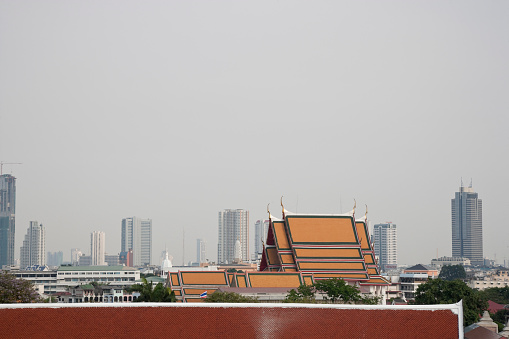 Bangkok skyline near Wat Arun, buddhist temple by the Chao Phraya River, Bangkok, Thailand.