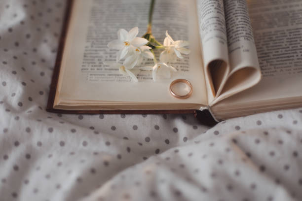 istock Wedding golden ring and open book with folded sheets in heart shape. Wedding concept, Valentines Day 1369173864
