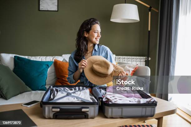 Portrait Of A Woman Preparing For A Trip Stock Photo - Download Image Now - Travel, Vacations, Suitcase