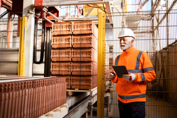 istock Factory worker supervisor controlling packaging process in factory production line. 1369175017