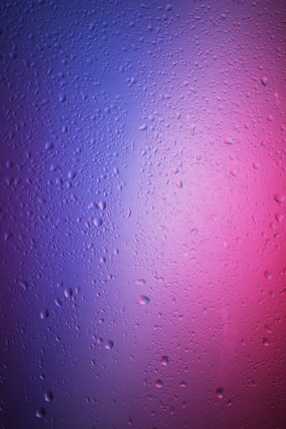 water drops on the glass surface on a colorful gradient background