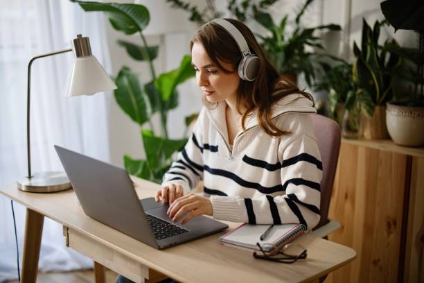 istock Young woman using laptop at home to work or study 1369175564
