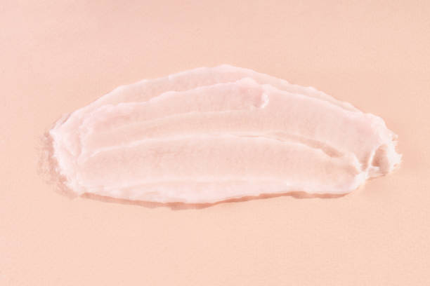 Creamy balm or mask smear on a beige background. stock photo