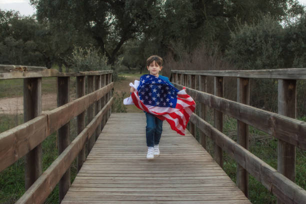 istock Child Holding American Flag While Running. 1369175638