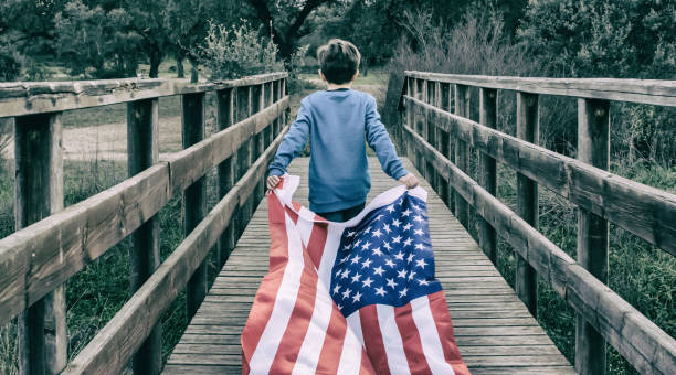 istock Child Holding American Flag While Running. 1369175662