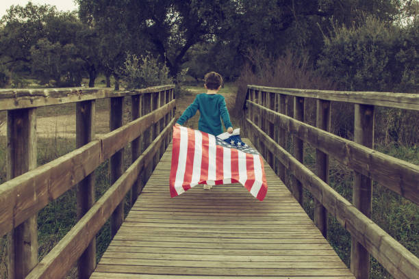 istock Child Holding American Flag While Running. 1369175680