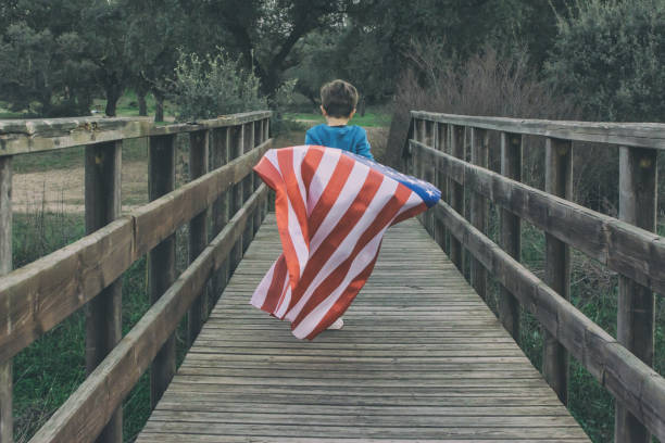 istock Child Holding American Flag While Running. 1369175686